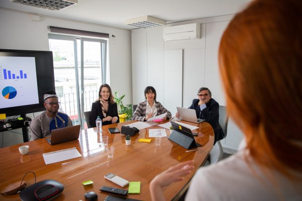 Business woman talking to her business partners at a meeting, multi ethnic group Business woman talking to her business partners at a meeting, multi ethnic group